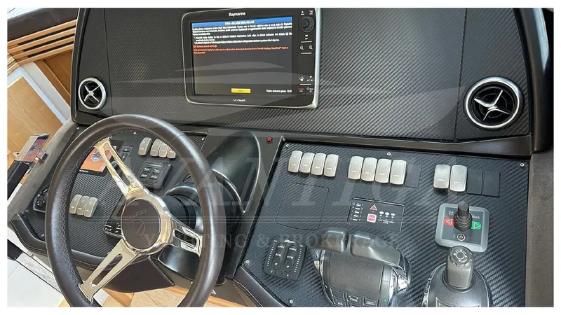  Yacht Photos Pics Cockpit of 2014 Absolute 52 FLY yacht with steering wheel and control panel.