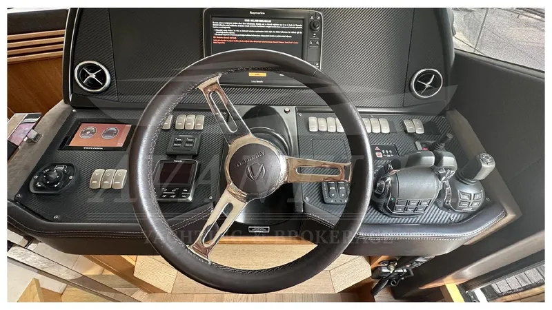  Yacht Photos Pics Steering wheel and controls of a 2014 Absolute 52 FLY yacht.