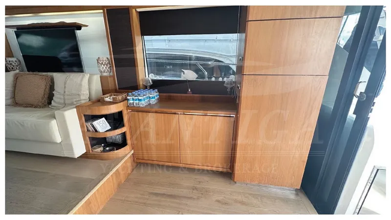  Yacht Photos Pics Interior of 2014 Absolute 52 FLY yacht with wooden cabinetry and seating area.