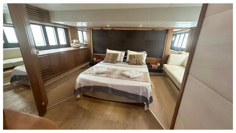  Yacht Photos Pics Luxurious bedroom interior of 2014 Absolute 52 FLY yacht with modern design and wooden accents.