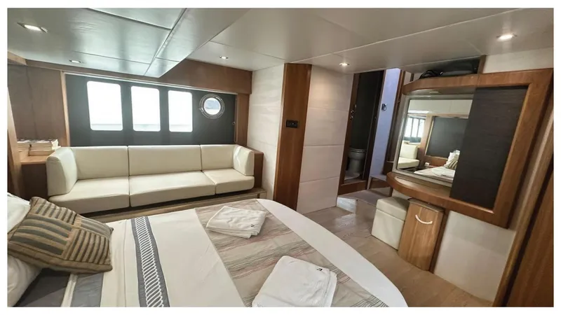  Yacht Photos Pics Luxurious interior of 2014 Absolute 52 FLY yacht with bed, sofa, and mirror.