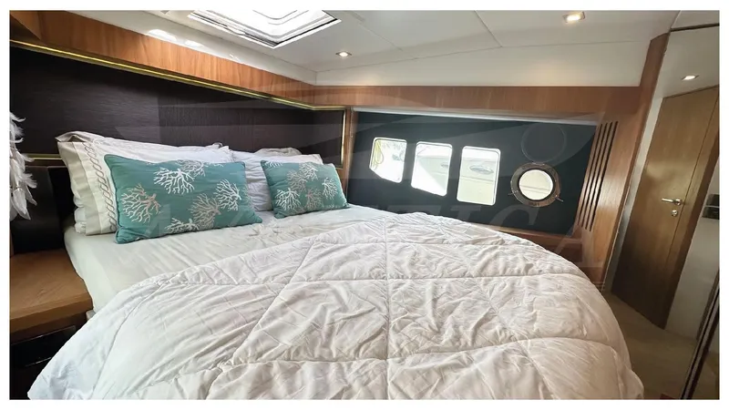  Yacht Photos Pics Luxurious bedroom interior of 2014 Absolute 52 FLY yacht with elegant bedding and porthole windows.