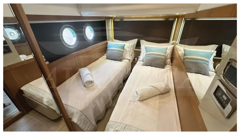 Yacht Photos Pics Luxurious twin cabin interior of 2014 Absolute 52 FLY yacht with porthole windows.