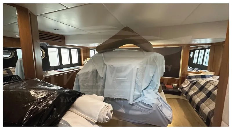  Yacht Photos Pics Interior of 2014 Absolute 52 FLY yacht with covered furnishings and cozy bedding.