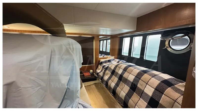  Yacht Photos Pics Interior cabin of 2014 Absolute 52 FLY yacht with cozy bedding and porthole windows.