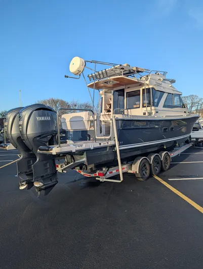  Yacht Photos Pics 2022 Cutwater C-32 CB boat on trailer with Yamaha engines in parking lot.