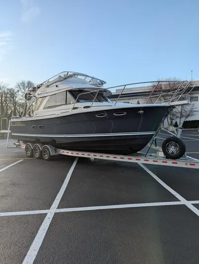  Yacht Photos Pics 2022 Cutwater C-32 CB boat on trailer in parking lot.