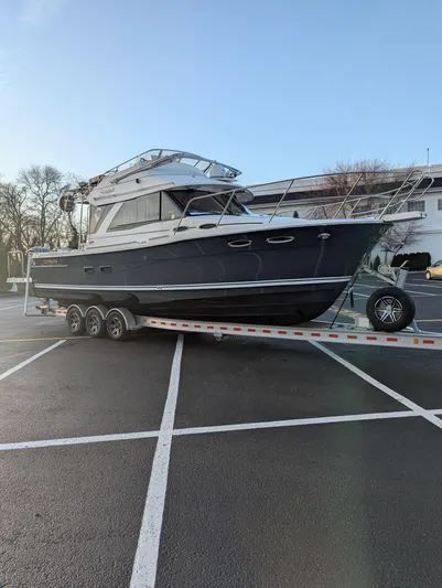  Yacht Photos Pics 2022 Cutwater C-32 CB boat on trailer in parking lot.