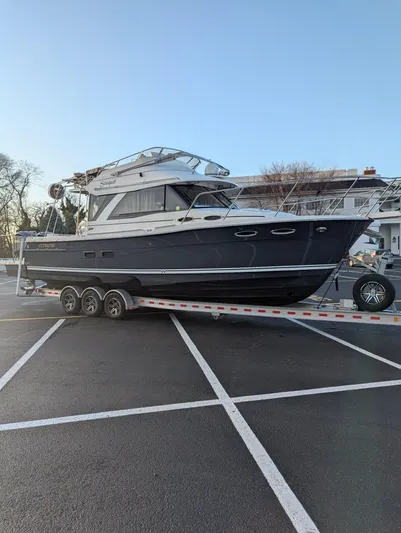  Yacht Photos Pics 2022 Cutwater C-32 CB boat on a trailer in a parking lot.