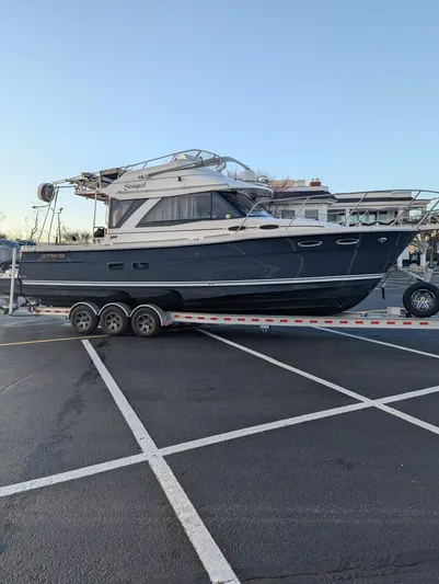  Yacht Photos Pics 2022 Cutwater C-32 CB boat on trailer in parking lot.