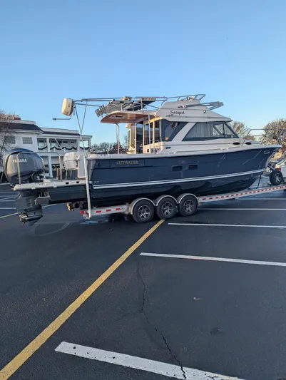  Yacht Photos Pics 2022 Cutwater C-32 CB boat on trailer in parking lot.