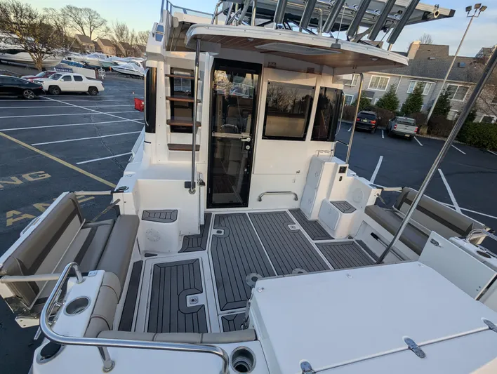  Yacht Photos Pics 2022 Cutwater C-32 CB boat with spacious deck and seating in a parking lot.