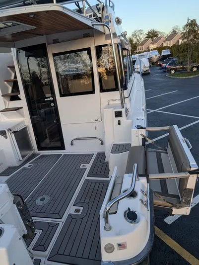  Yacht Photos Pics 2022 Cutwater C-32 CB boat with spacious deck and seating in a parking lot.