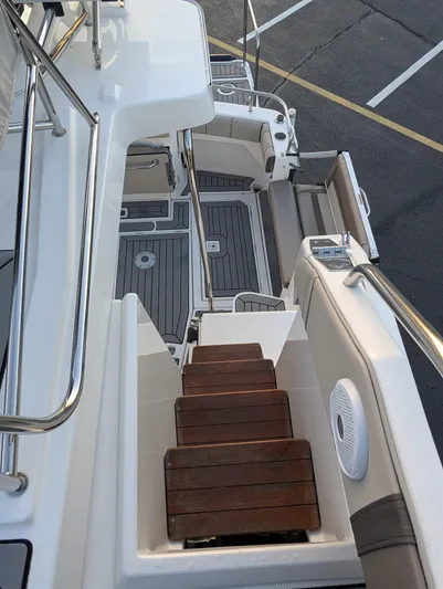  Yacht Photos Pics 2022 Cutwater C-32 CB boat interior with wooden steps and sleek design.