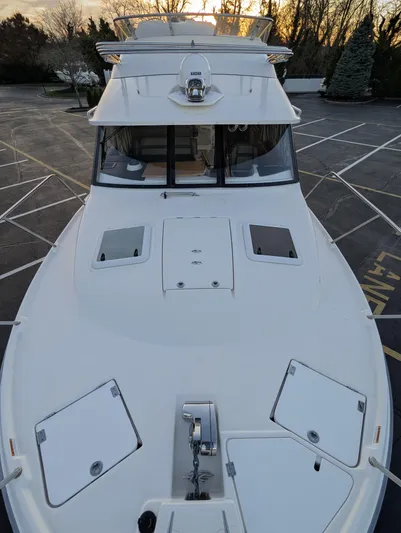  Yacht Photos Pics 2022 Cutwater C-32 CB boat, sleek design, docked at sunset.