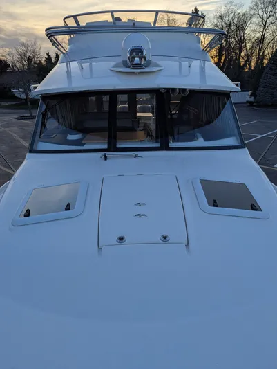  Yacht Photos Pics 2022 Cutwater C-32 CB boat, front view at sunset, docked in a marina.