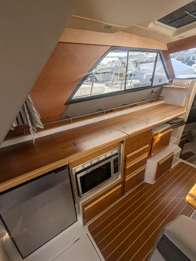  Yacht Photos Pics Interior of 2022 Cutwater C-32 CB yacht with modern kitchen and wood finishes.