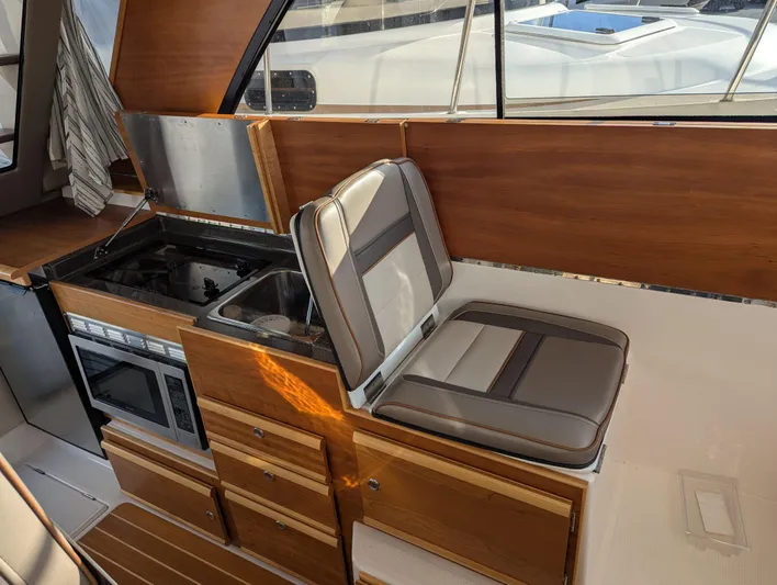  Yacht Photos Pics 2022 Cutwater C-32 CB interior with kitchen and seating area.