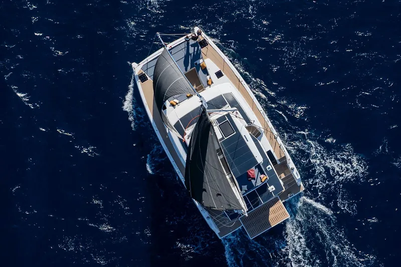 Voila Yacht Photos Pics Aerial view of 2026 Bali 5.2 yacht sailing on deep blue ocean waters.