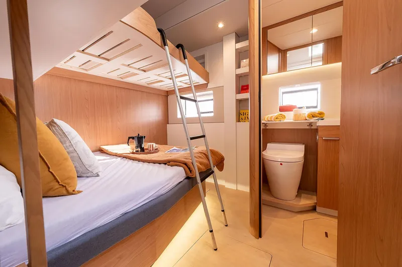 Voila Yacht Photos Pics Luxurious Bali 5.2 yacht cabin interior, featuring cozy bedding and modern bathroom, 2026 model.
