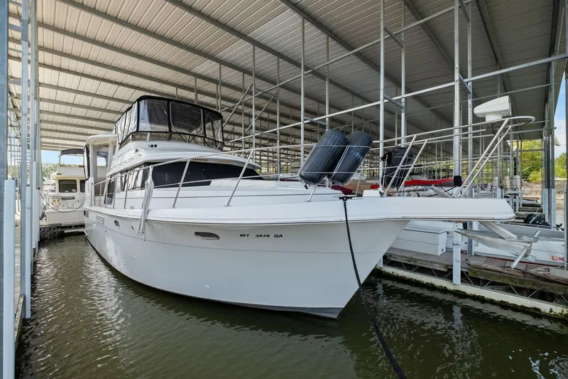 Starship Yacht Photos Pics 1996 Carver 440 Aft Cabin Motor Yacht docked in covered marina.