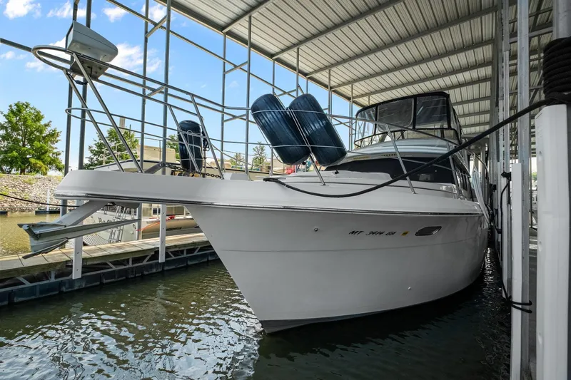 Starship Yacht Photos Pics 1996 Carver 440 Aft Cabin Motor Yacht docked in a covered marina.