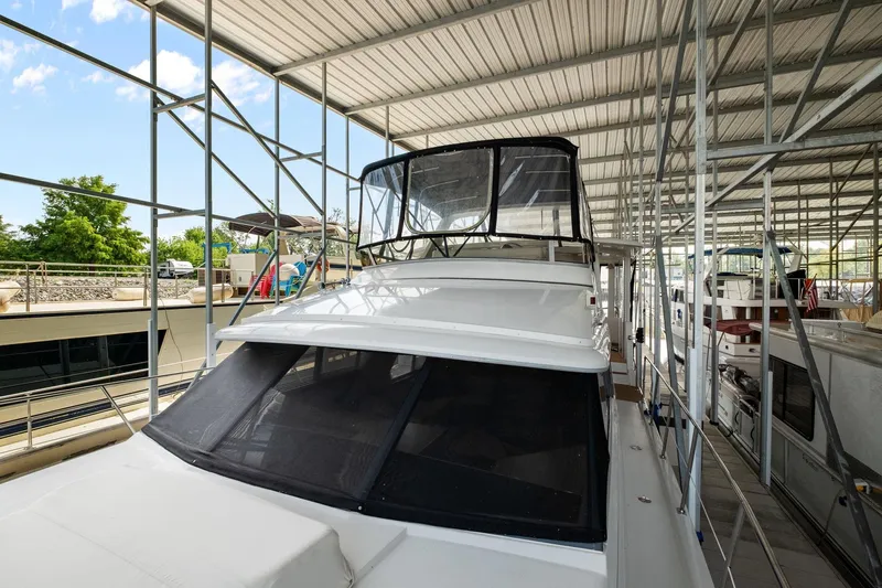 Starship Yacht Photos Pics 1996 Carver 440 Aft Cabin Motor Yacht docked in covered marina.