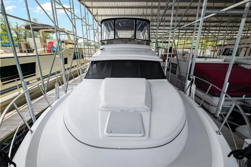 Starship Yacht Photos Pics 1996 Carver 440 Aft Cabin Motor Yacht docked in a covered marina.