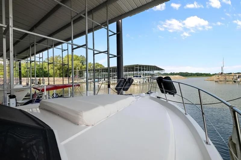 Starship Yacht Photos Pics 1996 Carver 440 Aft Cabin Motor Yacht docked in a marina under a covered structure.
