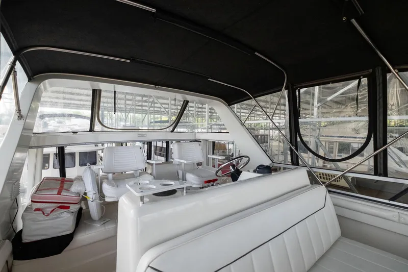 Starship Yacht Photos Pics 1996 Carver 440 Aft Cabin Motor Yacht interior with seating and helm station.