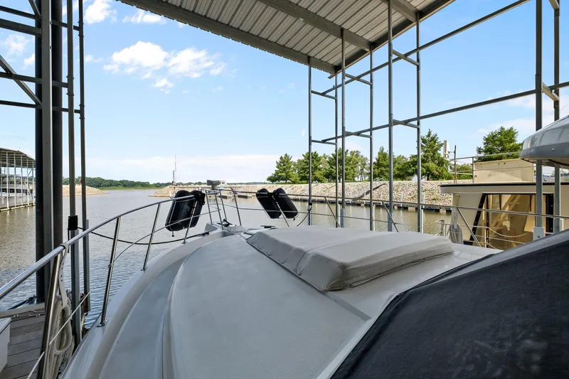 Starship Yacht Photos Pics 1996 Carver 440 Aft Cabin Motor Yacht docked under a covered marina.