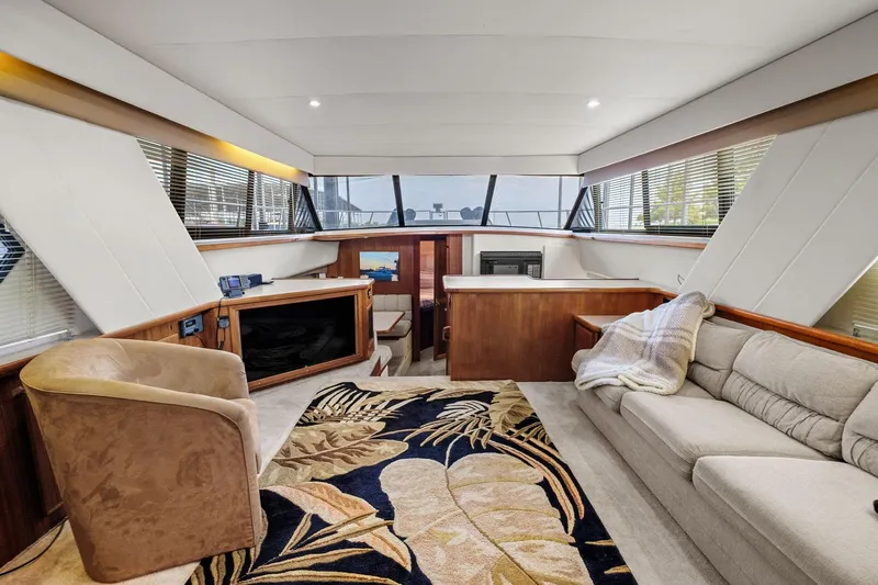 Starship Yacht Photos Pics Luxurious interior of 1996 Carver 440 Aft Cabin Motor Yacht with plush seating and elegant decor.