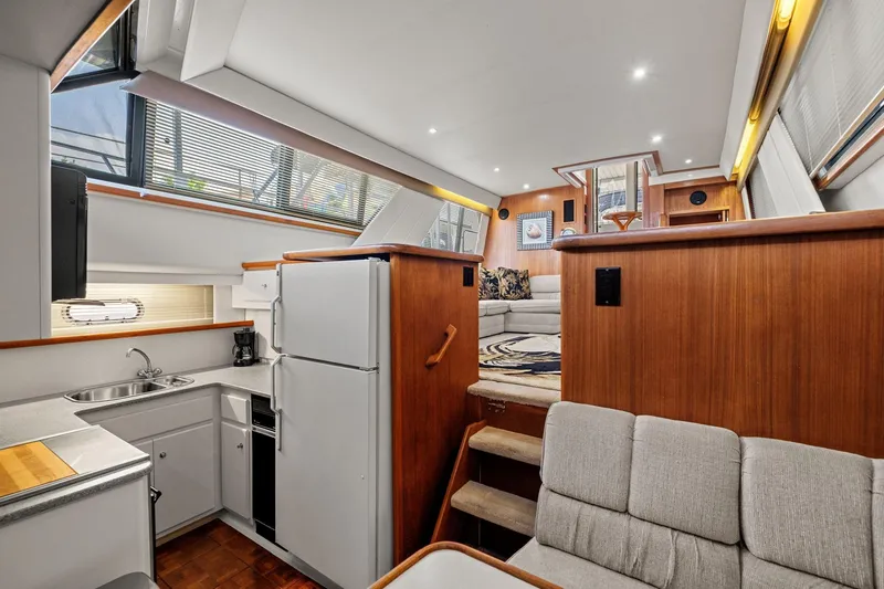 Starship Yacht Photos Pics 1996 Carver 440 Aft Cabin Motor Yacht interior with kitchen and seating area.