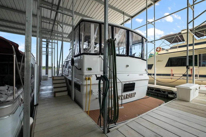 Starship Yacht Photos Pics 1996 Carver 440 Aft Cabin Motor Yacht docked in a marina.