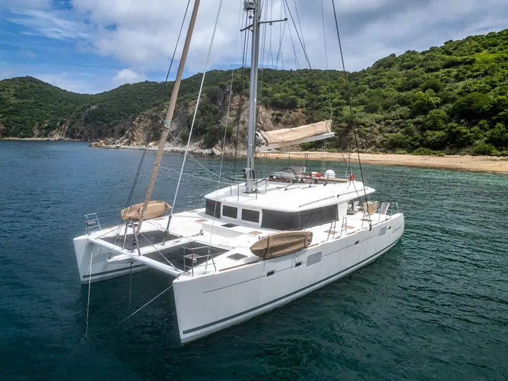 Cascadia 2 Yacht Photos Pics Luxurious 2012 Lagoon 560 catamaran anchored in a scenic bay with lush green hills.