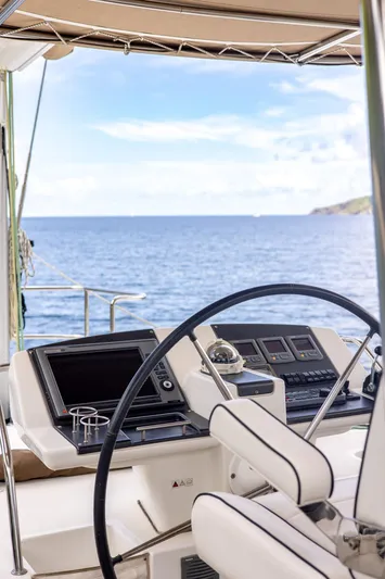 Cascadia 2 Yacht Photos Pics Helm of 2012 Lagoon 560 catamaran with ocean view and modern navigation equipment.