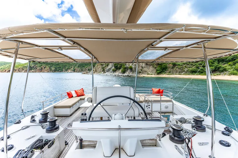 Cascadia 2 Yacht Photos Pics Luxurious 2012 Lagoon 560 yacht deck with helm, seating, and scenic ocean view.