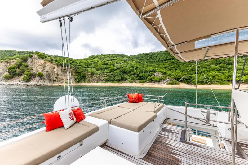 Cascadia 2 Yacht Photos Pics Luxurious 2012 Lagoon 560 yacht deck with scenic coastal view and comfortable seating.