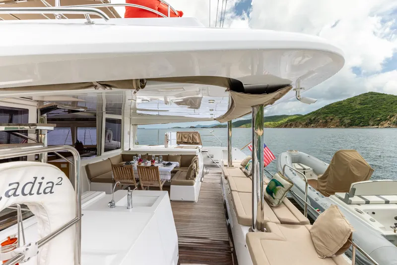 Cascadia 2 Yacht Photos Pics Luxurious 2012 Lagoon 560 yacht with spacious deck, dining area, and scenic ocean view.