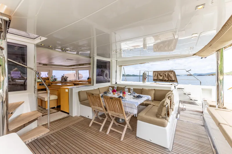 Cascadia 2 Yacht Photos Pics Luxurious Lagoon 560 yacht interior with dining area, wooden flooring, and ocean view, 2012 model.