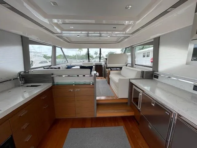 Nexlevel Yacht Photos Pics 2019 Tiara Yachts C53 Coupe interior with modern kitchen and seating area.