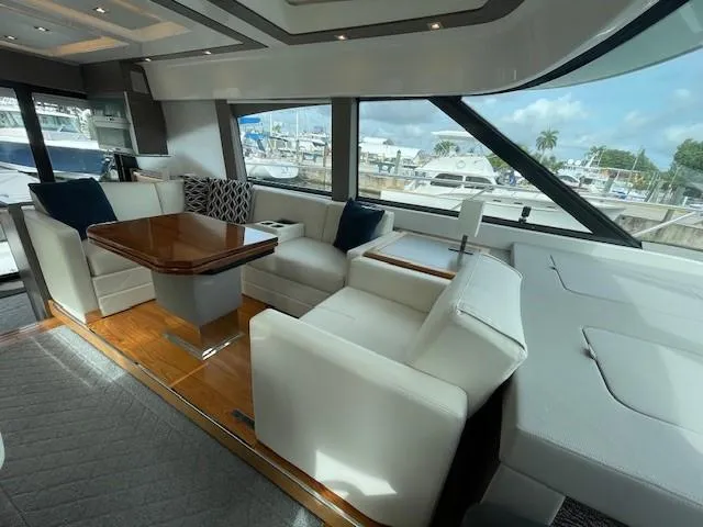 Nexlevel Yacht Photos Pics 2019 Tiara Yachts C53 Coupe interior with luxurious seating and marina view.