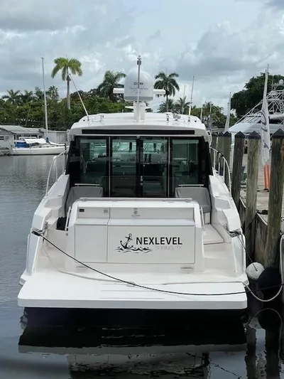 Nexlevel Yacht Photos Pics 2019 Tiara Yachts C53 Coupe docked at marina, rear view.