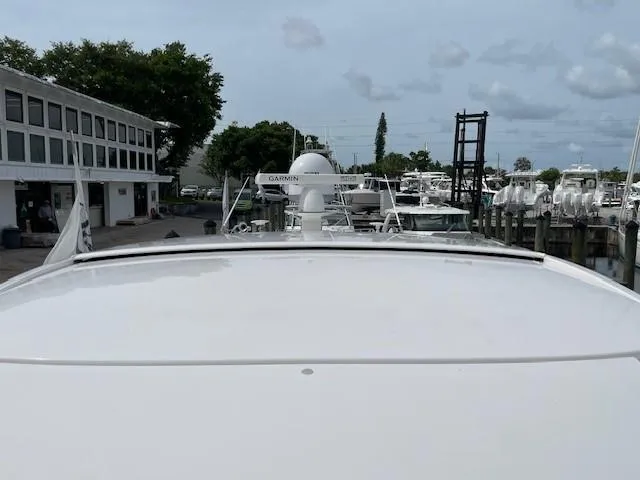 Nexlevel Yacht Photos Pics 2019 Tiara Yachts C53 Coupe docked at a marina with other boats.