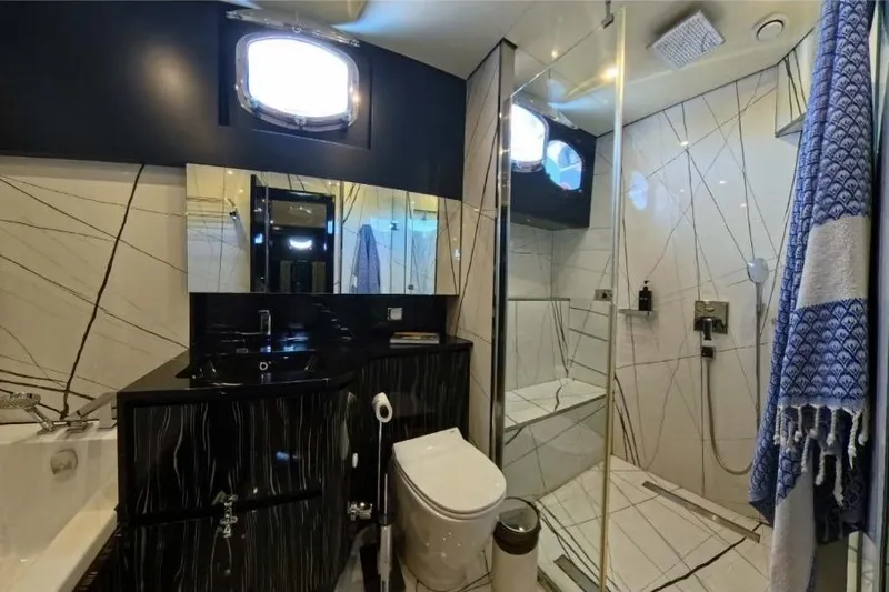 Odisea Yacht Photos Pics Luxurious bathroom in 2006 Custom Mahogany Gulet, featuring modern shower and elegant fixtures.