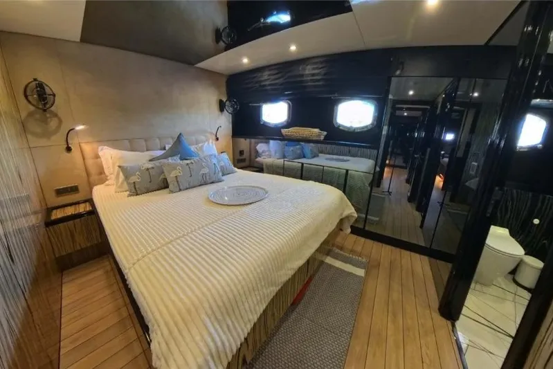 Odisea Yacht Photos Pics Luxurious cabin interior of 2006 Custom Mahogany Expedition Gulet with elegant bedding and modern amenities.