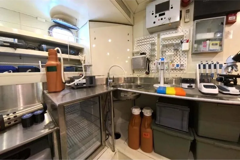 Odisea Yacht Photos Pics Laboratory setup inside a 2006 Custom Mahogany Expedition Gulet, featuring scientific equipment and storage.