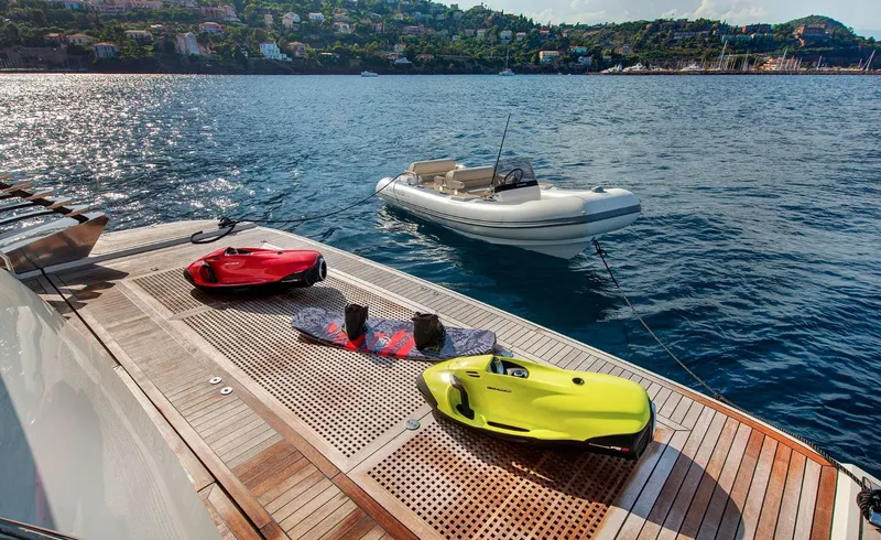 Esmeralda Of The Seas Yacht Photos Pics Monte Carlo Yachts MCY 96, 2018 model, with water sports equipment on deck, scenic coastal view.