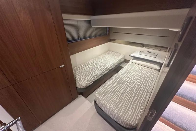  Yacht Photos Pics Luxurious twin cabin interior of 2020 Princess S62 yacht with modern wood finishes.