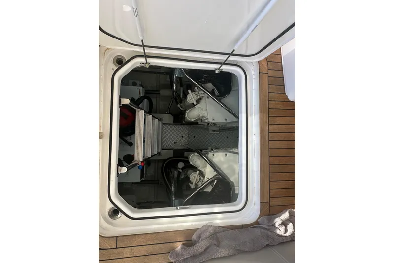  Yacht Photos Pics Engine compartment of a 2020 Princess S62 yacht, showcasing mechanical components and deck flooring.